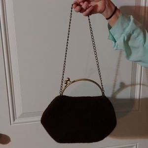 Brown purse with brass hardware